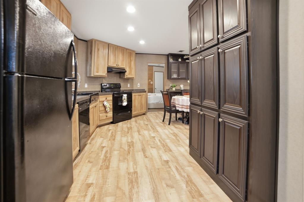 127 Almond Road Minden, LA 71055 - Photo 10 of 25 a kitchen with stainless steel appliances granite countertop a refrigerator stove microwave and sink