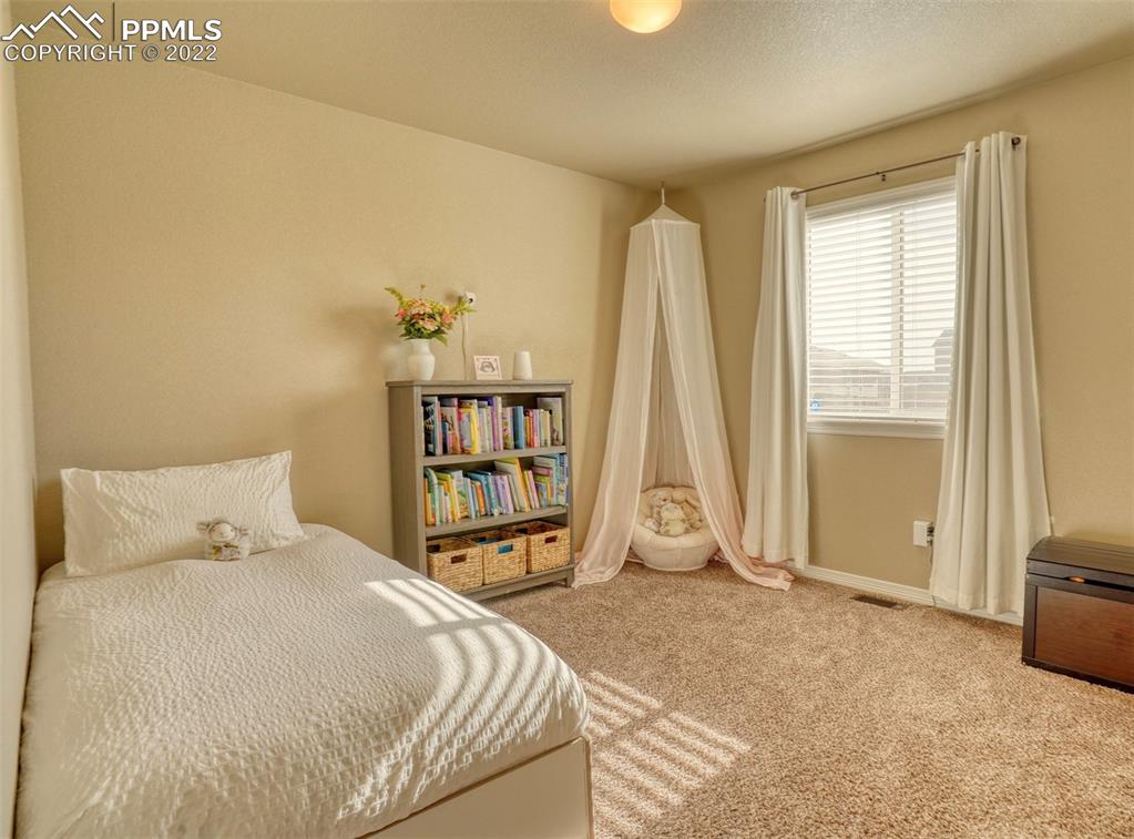 6729 Kearsarge Drive Colorado Springs, CO 80925 - Photo 11 of 22 a bedroom with a bed and a window