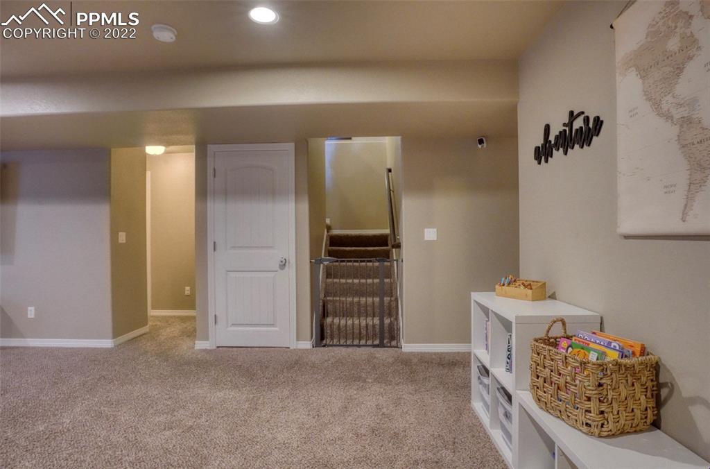 6729 Kearsarge Drive Colorado Springs, CO 80925 - Photo 13 of 22 a bedroom with a bed and cabinets