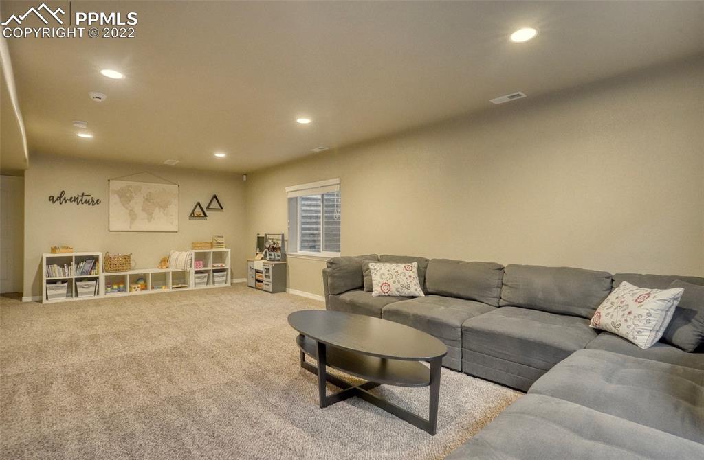6729 Kearsarge Drive Colorado Springs, CO 80925 - Photo 15 of 22 a living room with furniture and a table