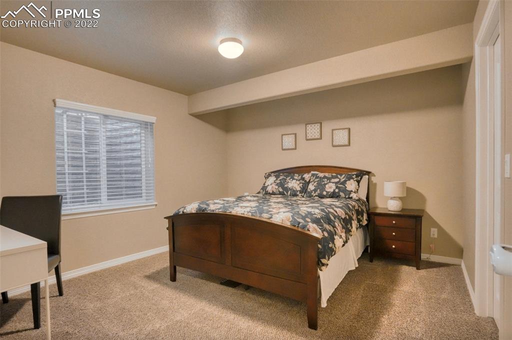 6729 Kearsarge Drive Colorado Springs, CO 80925 - Photo 17 of 22 a bedroom with a bed and a window