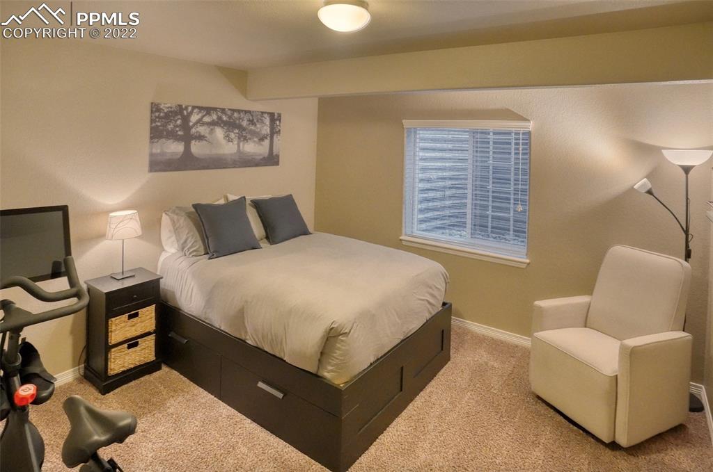 6729 Kearsarge Drive Colorado Springs, CO 80925 - Photo 18 of 22 a bedroom with a bed and lamp