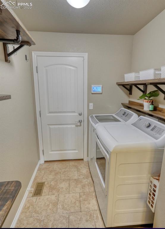 6729 Kearsarge Drive Colorado Springs, CO 80925 - Photo 20 of 22 a utility room with cabinets washer and dryer