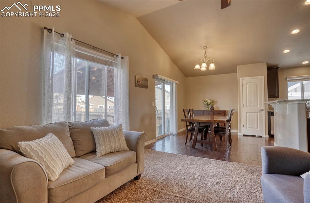 6729 Kearsarge Drive Colorado Springs, CO 80925 - Photo 6 of 22 a living room with furniture a dining table and a large window