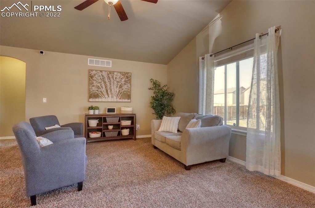 6729 Kearsarge Drive Colorado Springs, CO 80925 - Photo 7 of 22 a living room with furniture and a flat screen tv