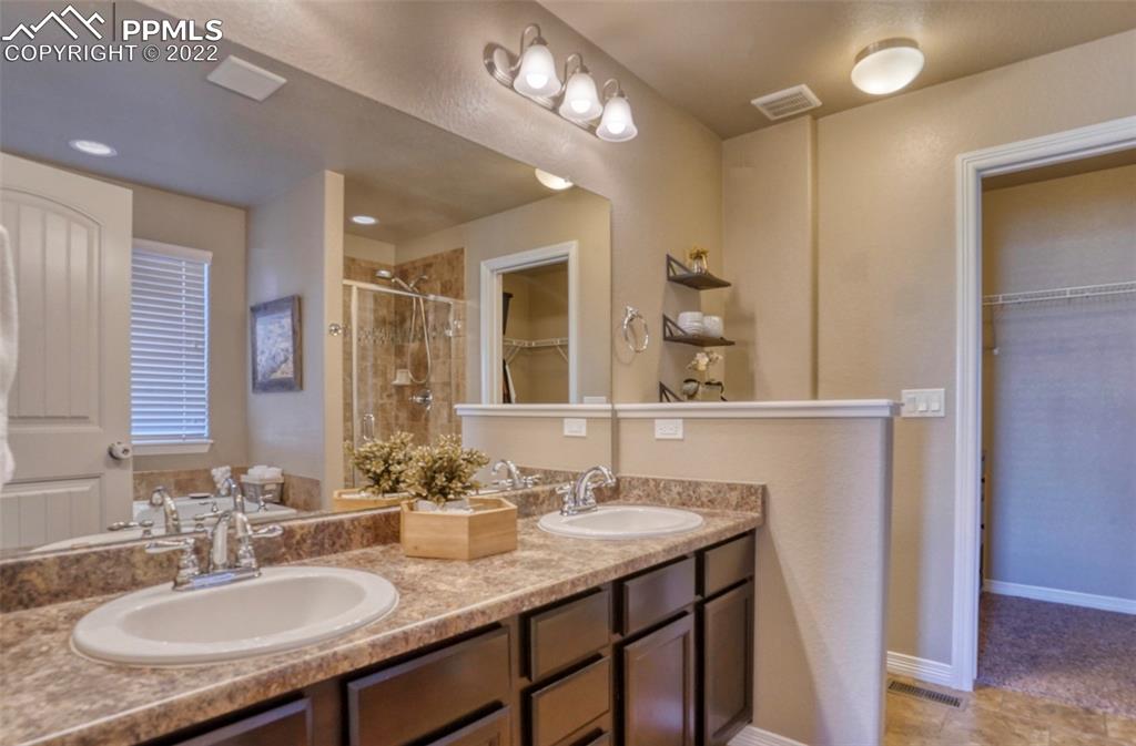 6729 Kearsarge Drive Colorado Springs, CO 80925 - Photo 9 of 22 a bathroom with a sink double vanity granite and a mirror