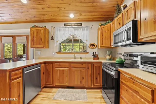 a kitchen with stainless steel appliances granite countertop a sink and cabinets