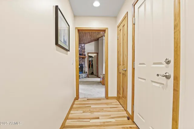 a view of a hallway with wooden floor and staircase