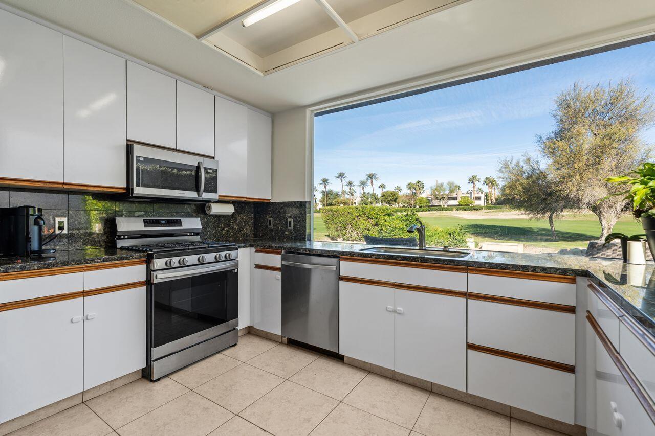 6 Pebble Beach Drive Rancho Mirage, CA 92270 - Photo 13 of 46 a kitchen with granite countertop cabinets stainless steel appliances and a counter space