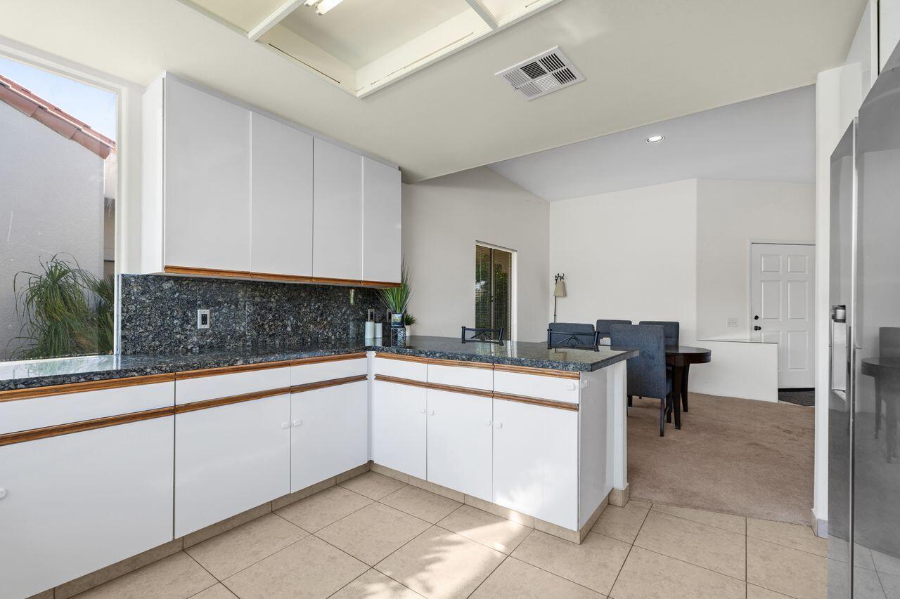 6 Pebble Beach Drive Rancho Mirage, CA 92270 - Photo 15 of 46 a kitchen with a sink and cabinets