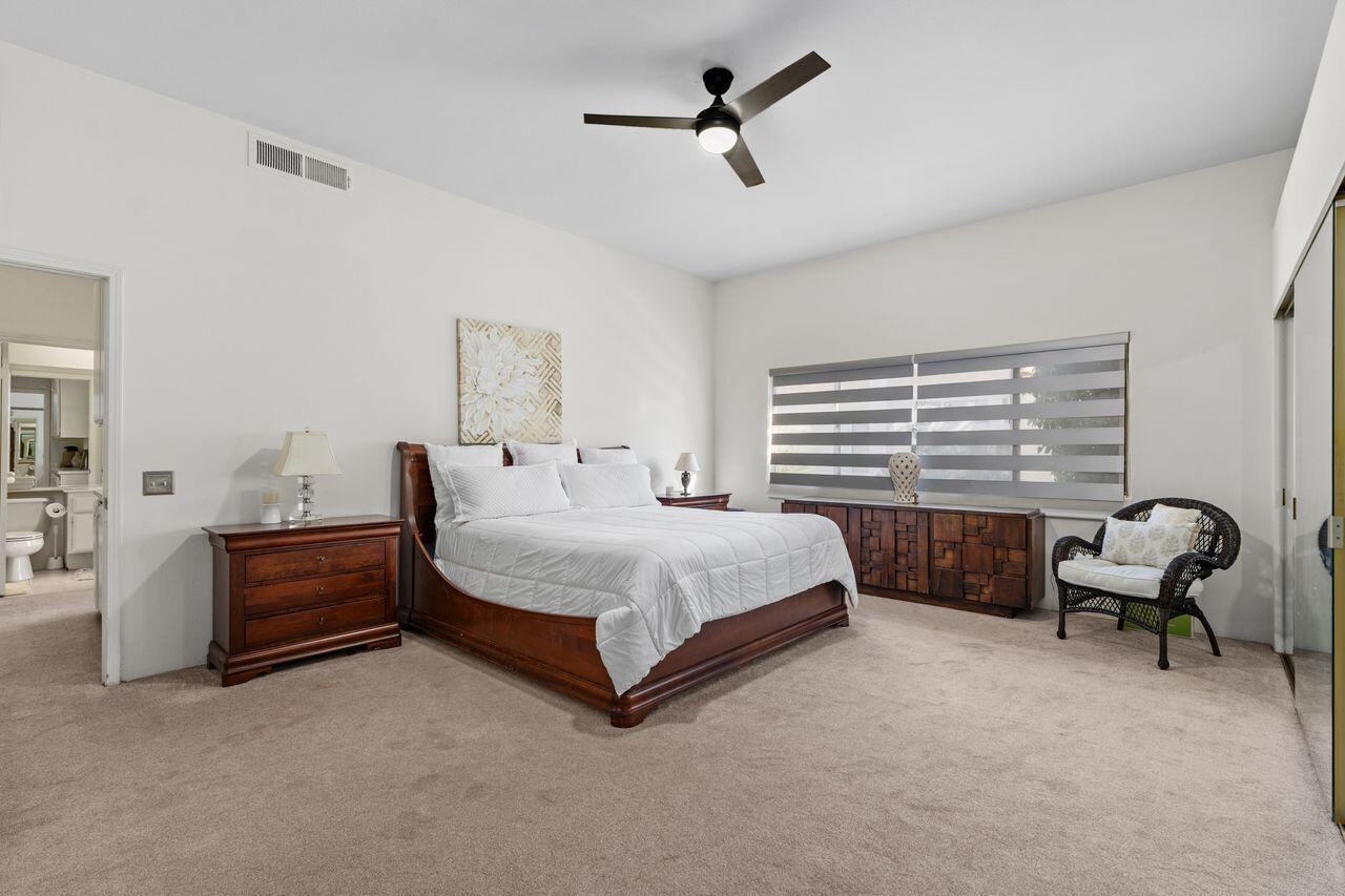 6 Pebble Beach Drive Rancho Mirage, CA 92270 - Photo 17 of 46 a spacious bedroom with a bed and a couch