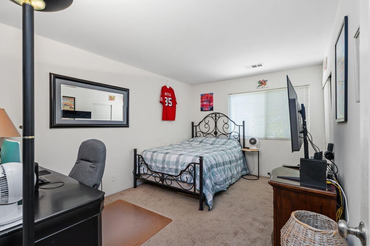 6 Pebble Beach Drive Rancho Mirage, CA 92270 - Photo 18 of 44 a bedroom with a bed and a chair