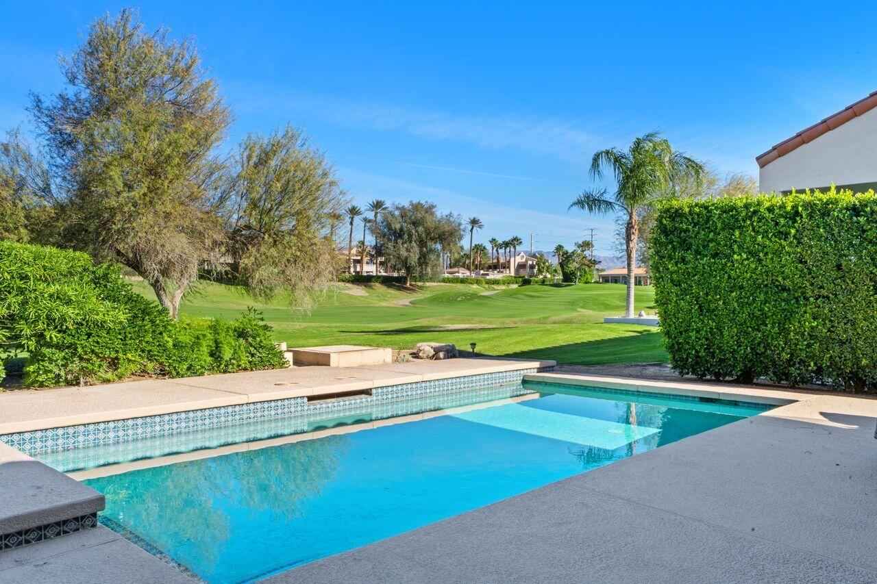 6 Pebble Beach Drive Rancho Mirage, CA 92270 - Photo 2 of 46 a view of a swimming pool and a yard