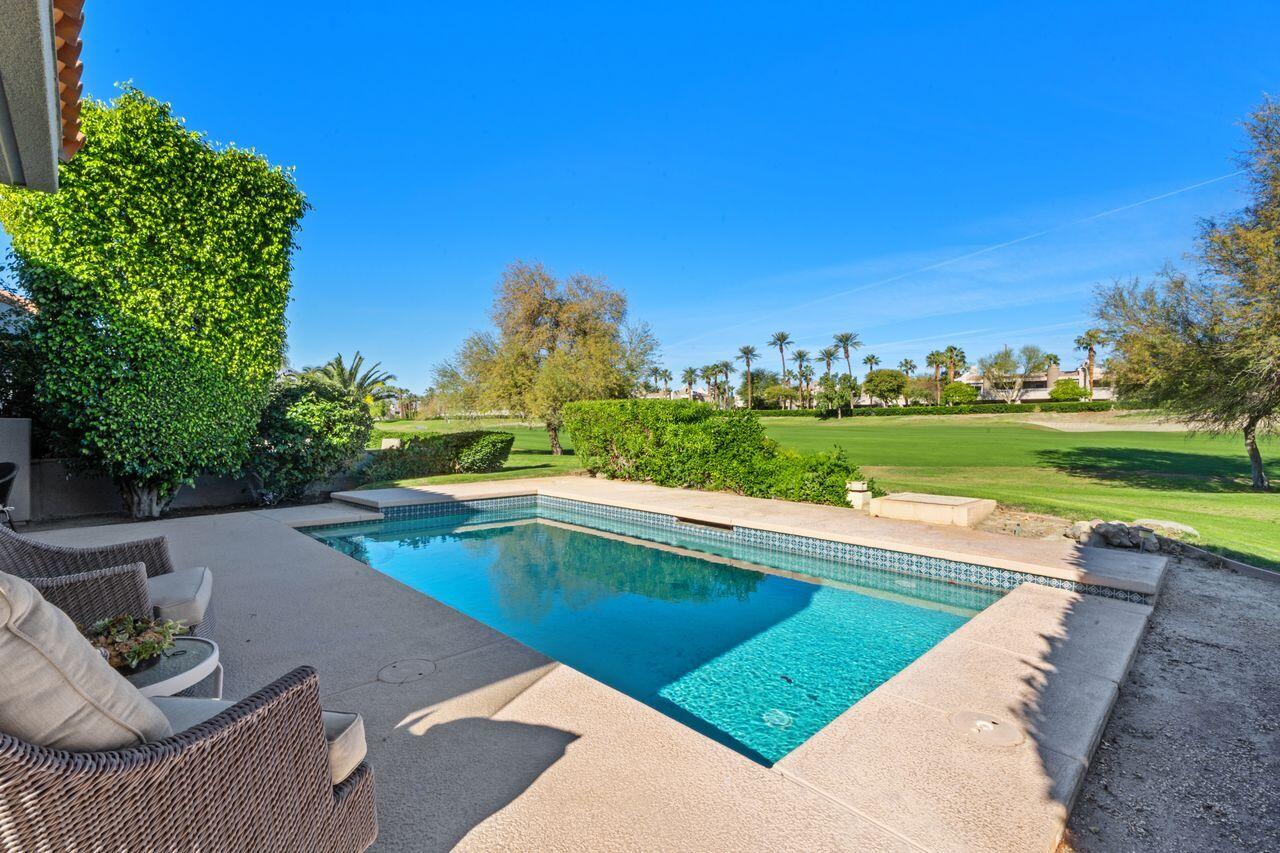 6 Pebble Beach Drive Rancho Mirage, CA 92270 - Photo 25 of 44 a view of a swimming pool and a yard