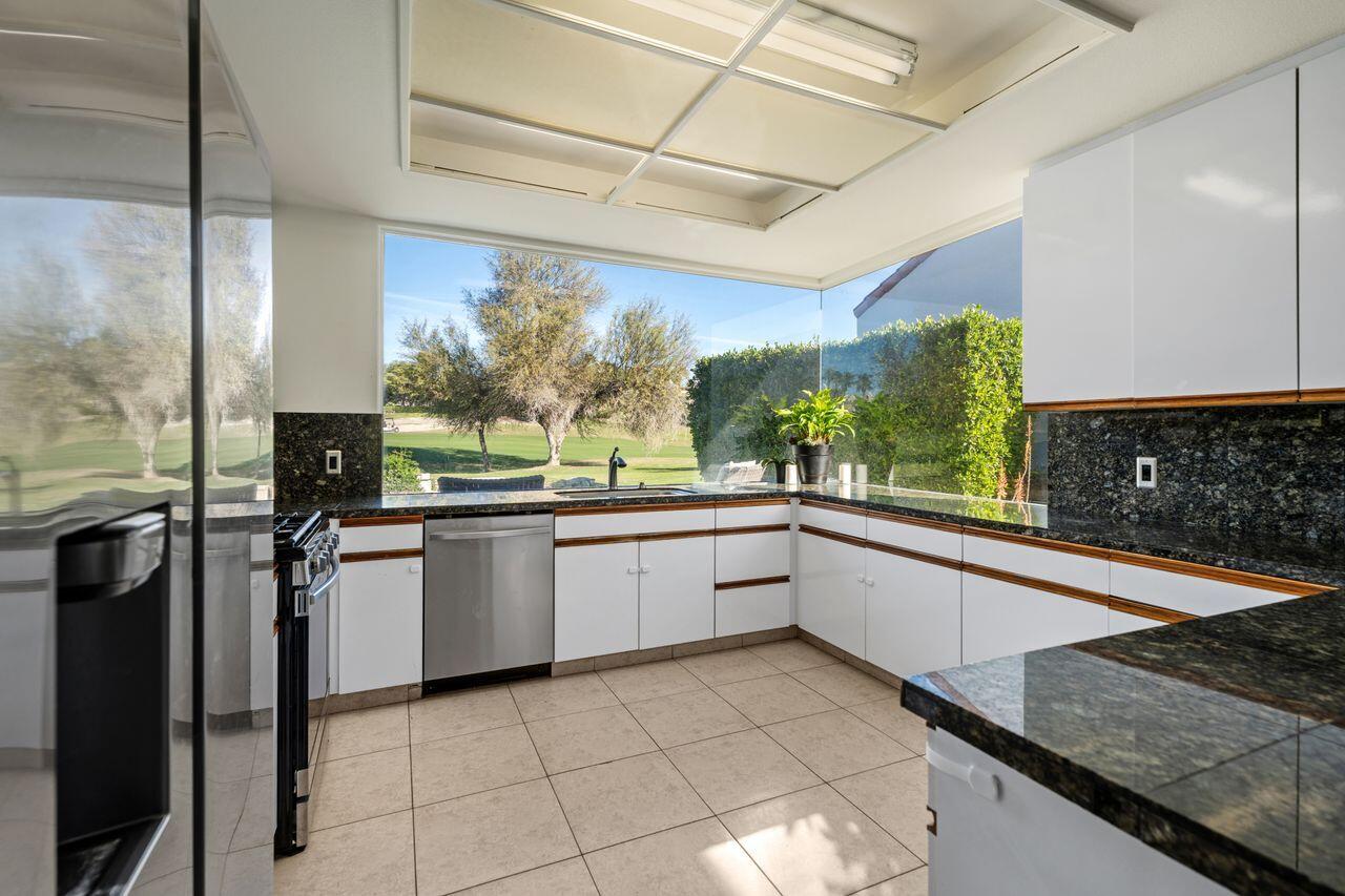 6 Pebble Beach Drive Rancho Mirage, CA 92270 - Photo 9 of 44 a large white kitchen with a large window
