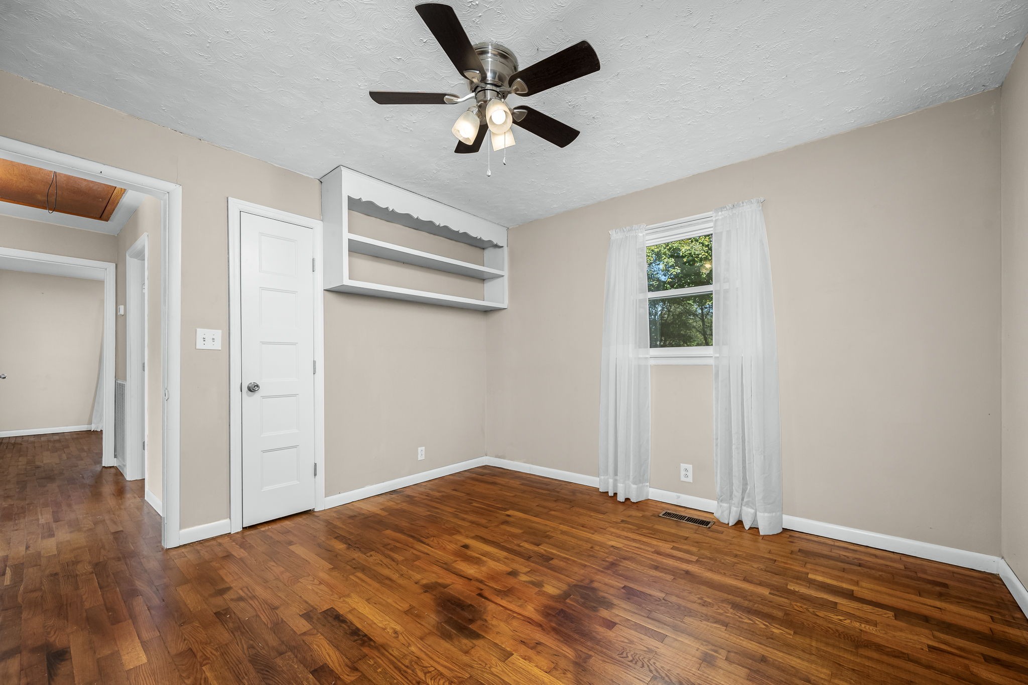 8 West Point Drive Fayetteville, TN 37334 - Photo 22 of 45 an empty room with wooden floor ceiling fan and windows