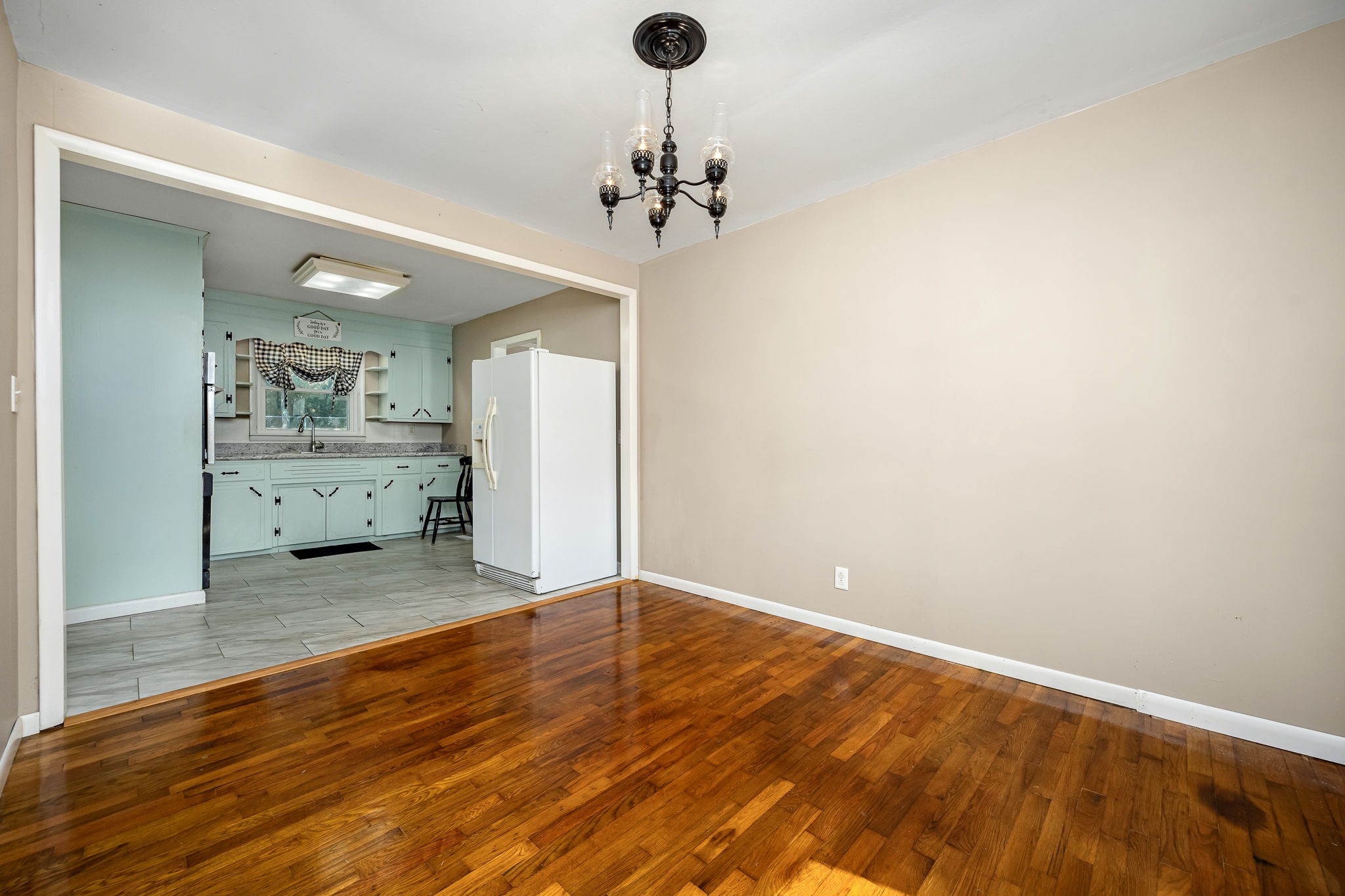 8 West Point Drive Fayetteville, TN 37334 - Photo 6 of 45 wooden floor in an empty room with a kitchen