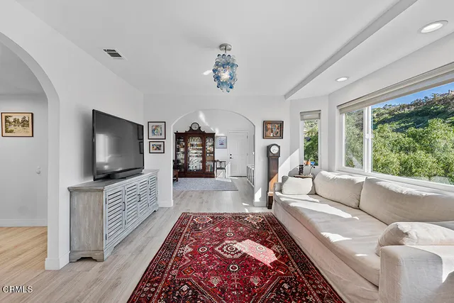 a view of a hallway with wooden floor and entryway