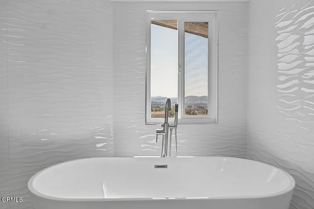 a view of a workspace with furniture and a bookshelf