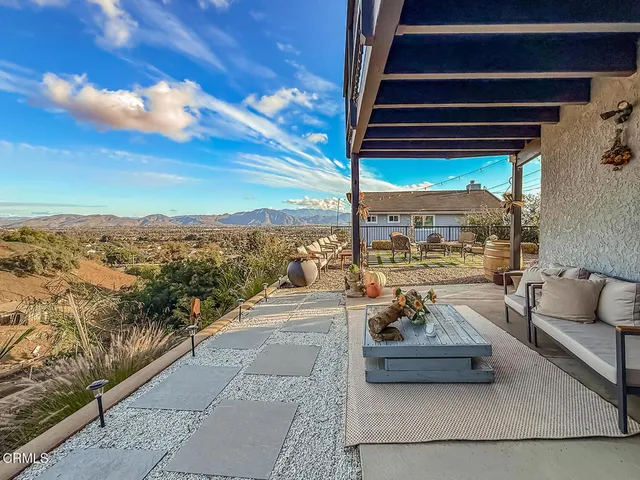 a view of a dry yard with mountains in the background