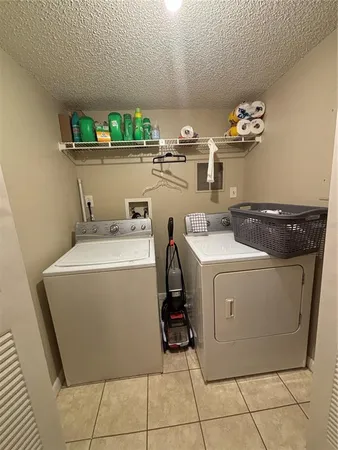 a kitchen with stainless steel appliances granite countertop a stove a refrigerator and a white cabinets