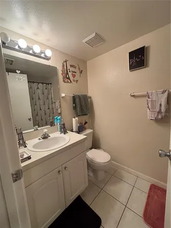 a view of bathroom with a toilet sink and mirror