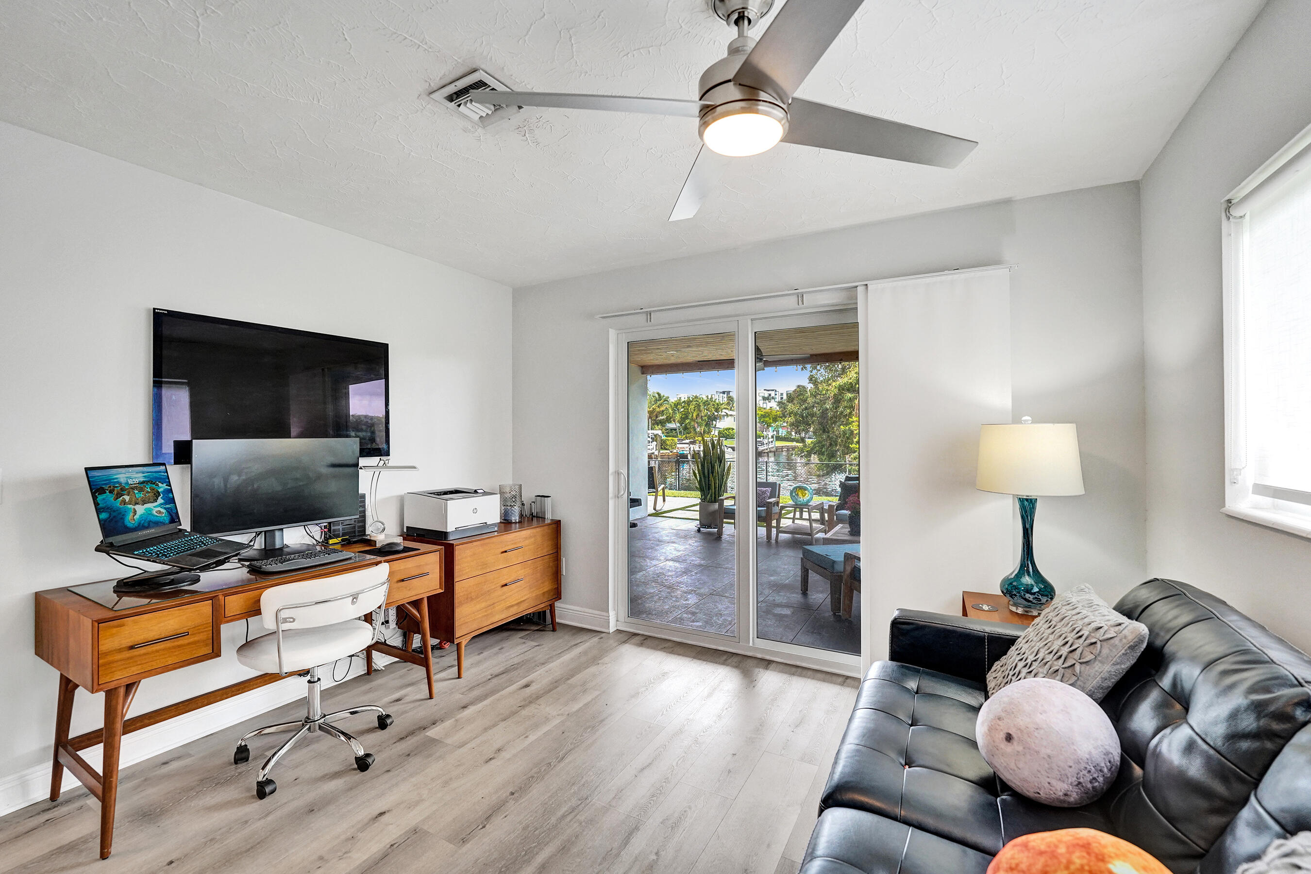 381 Southeast 3rd Street Pompano Beach, FL 33060 - Photo 25 of 41 a living room with furniture and a flat screen tv