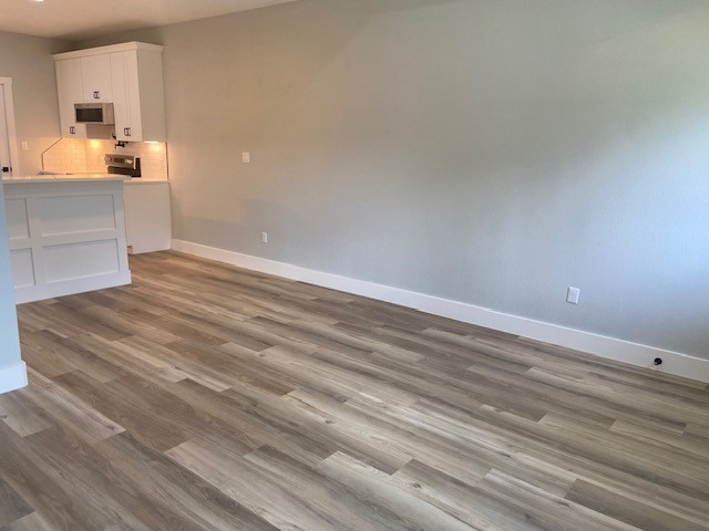 116 Field Street Luling, TX 78648 - Photo 30 of 33 A harmonious open-concept living area boasts a modern kitchen with a convenient breakfast bar.