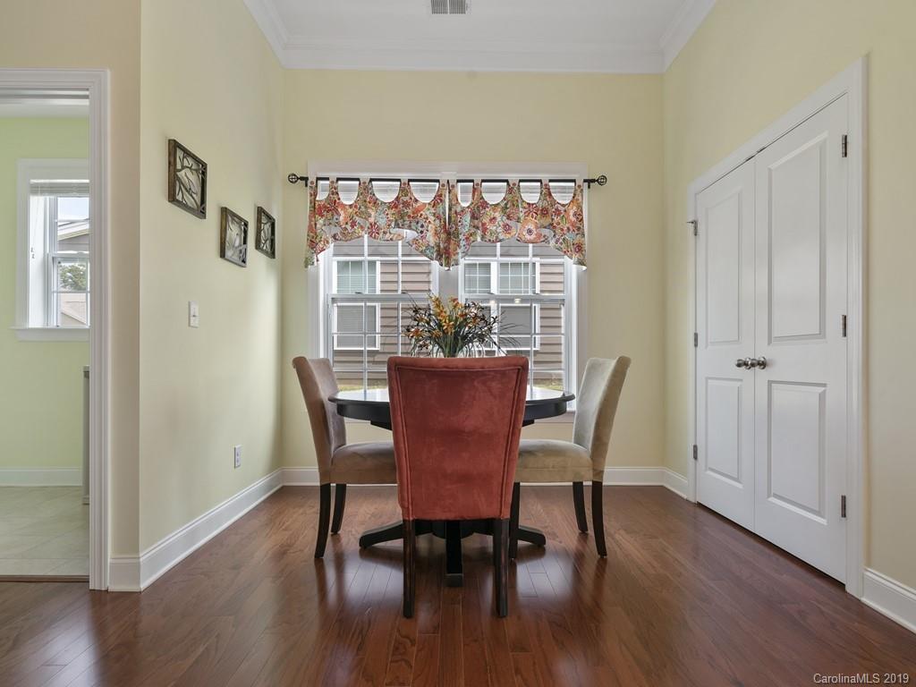 1821 Larkspur Way Tega Cay, SC 29708 - Photo 13 of 26 a view of a dining room with furniture window and wooden floor