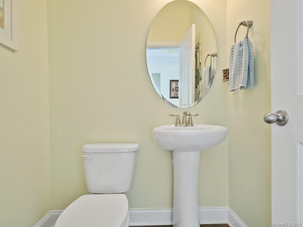 1821 Larkspur Way Tega Cay, SC 29708 - Photo 15 of 26 a bathroom with a toilet sink and mirror