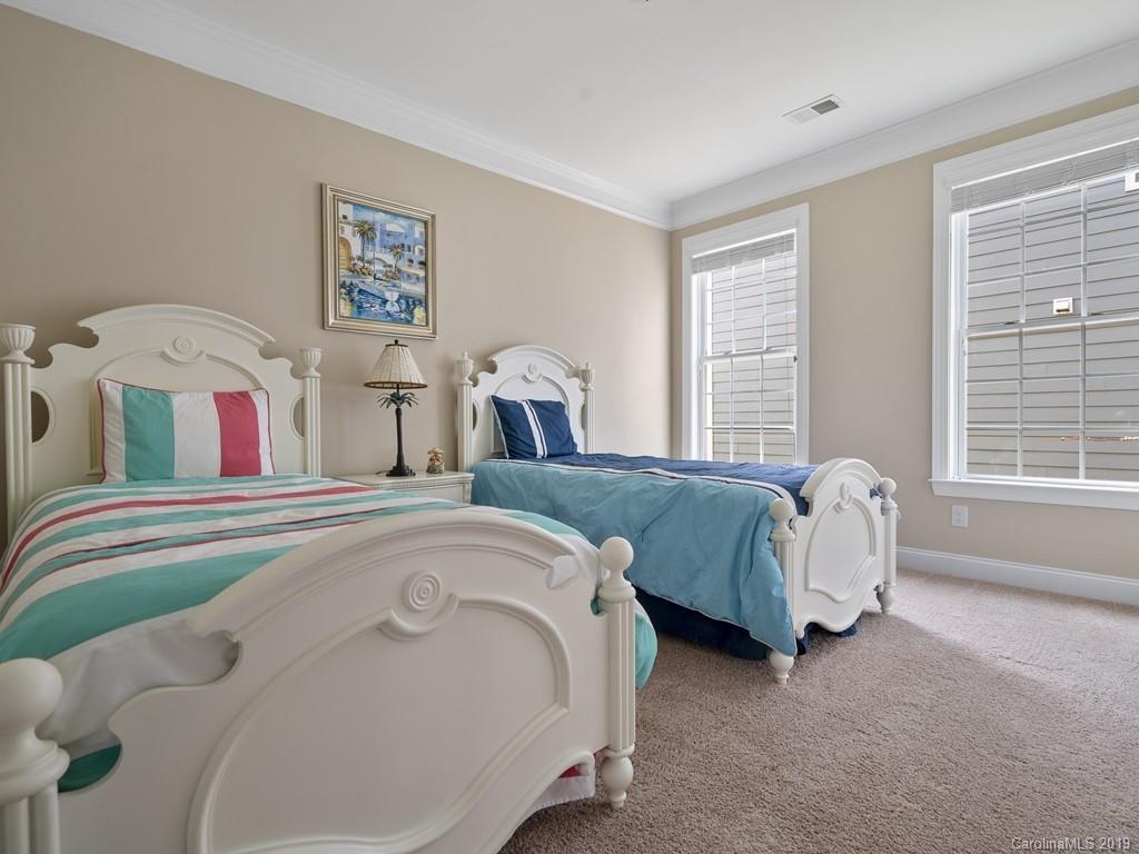 1821 Larkspur Way Tega Cay, SC 29708 - Photo 17 of 26 a spacious bedroom with bed and a window