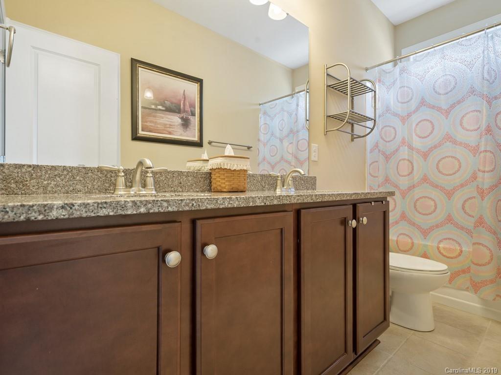 1821 Larkspur Way Tega Cay, SC 29708 - Photo 18 of 26 a bathroom with a granite countertop sink and a mirror