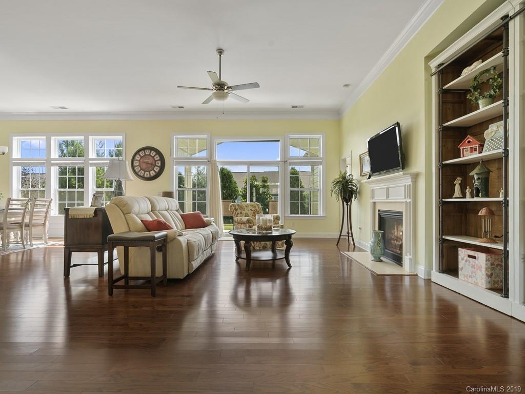 1821 Larkspur Way Tega Cay, SC 29708 - Photo 3 of 26 a living room with fireplace furniture and a flat screen tv