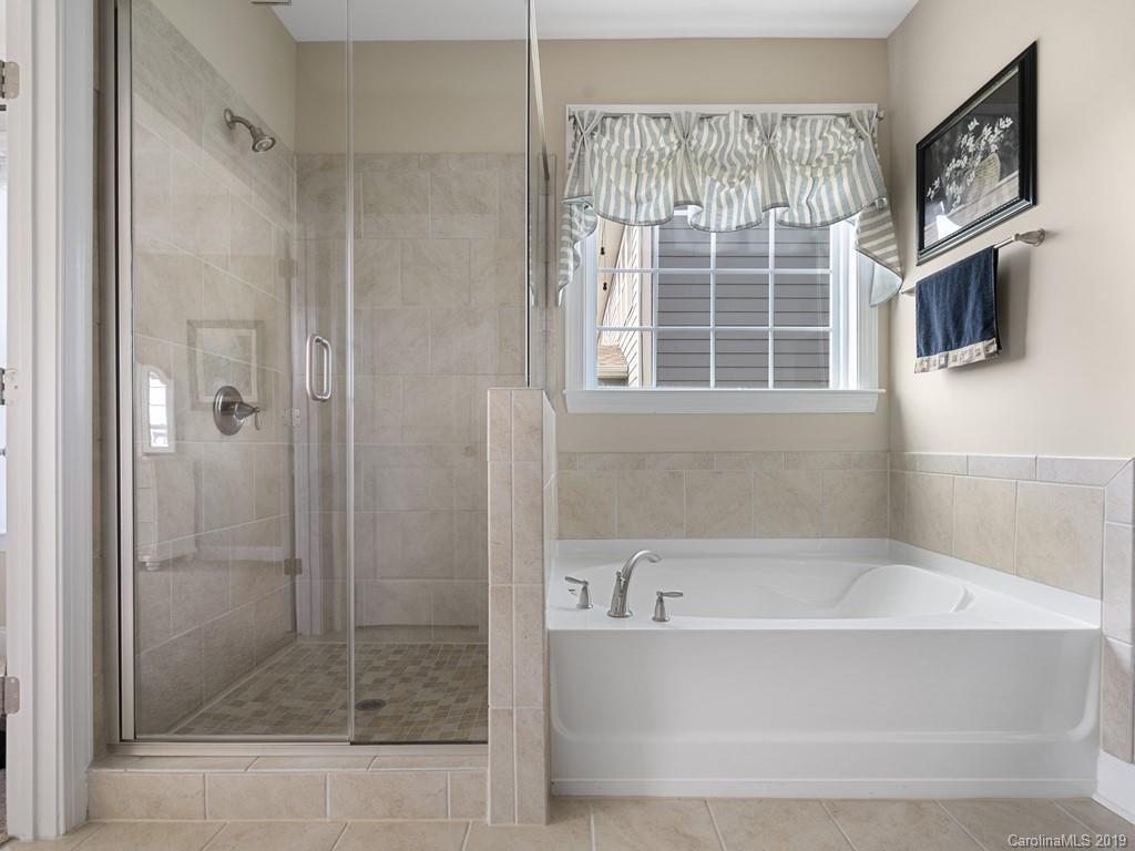 1821 Larkspur Way Tega Cay, SC 29708 - Photo 22 of 26 a bathroom with a bathtub and a shower
