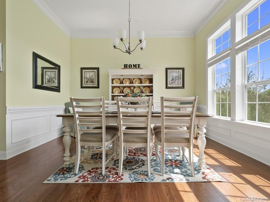 1821 Larkspur Way Tega Cay, SC 29708 - Photo 6 of 26 a view of a dining room with furniture wooden floor and chandelier