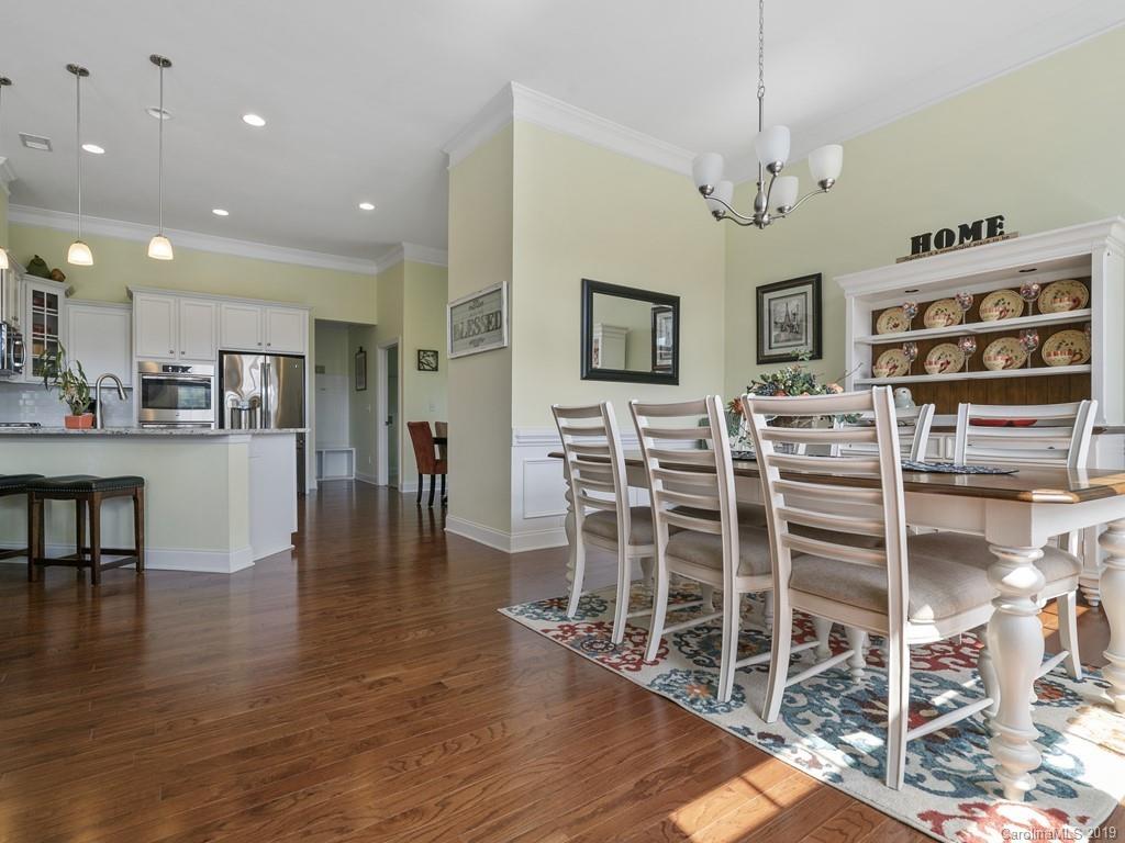 1821 Larkspur Way Tega Cay, SC 29708 - Photo 7 of 26 a view of a dining room with furniture and wooden floor