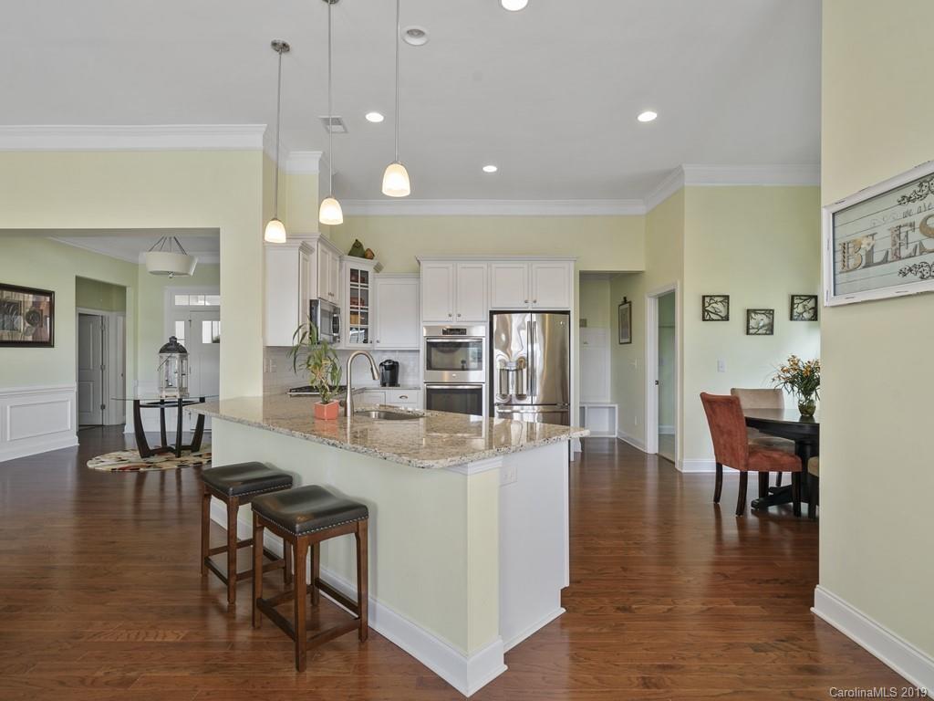 1821 Larkspur Way Tega Cay, SC 29708 - Photo 8 of 26 a view of a dining room with furniture and wooden floor