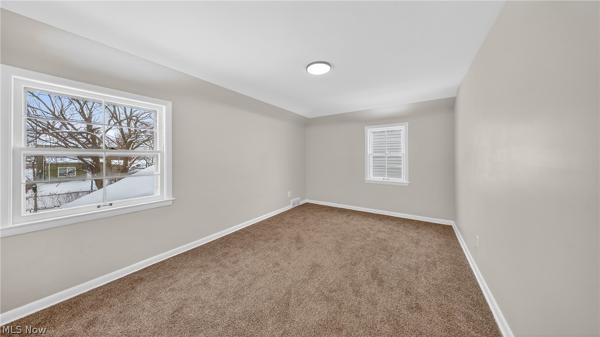 16811 Invermere Avenue Cleveland, OH 44128 - Photo 30 of 47 Carpeted empty room with healthy amount of natural light