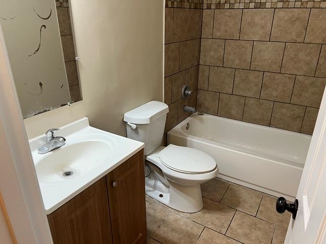 5183 Sea Shore Road Memphis, TN 38109 - Photo 17 of 17 Full bathroom with tile patterned flooring, toilet, tiled shower / bath, and vanity
