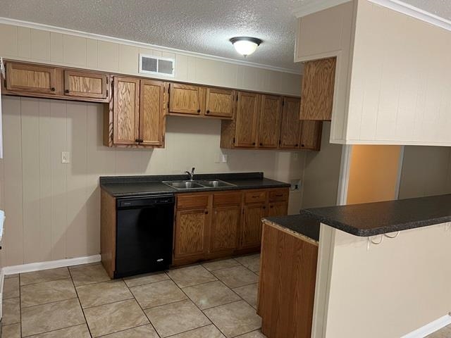 5183 Sea Shore Road Memphis, TN 38109 - Photo 5 of 17 Kitchen with crown molding, sink, kitchen peninsula, a textured ceiling, and black dishwasher