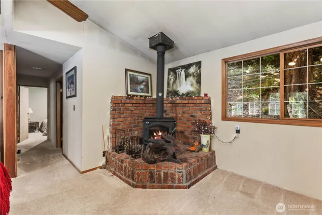 a living room with fireplace furniture and a large window