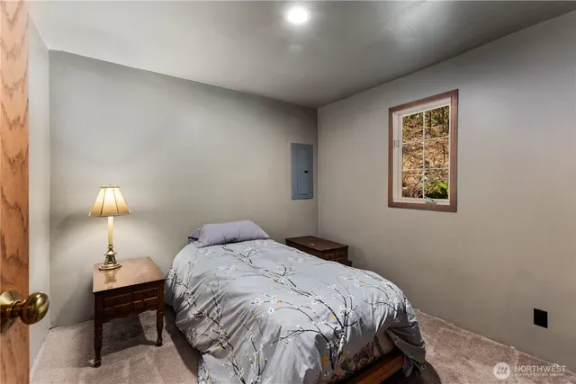 a bedroom with a bed and a lamp