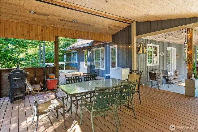 a view of a patio with table and chairs potted plants with wooden floor