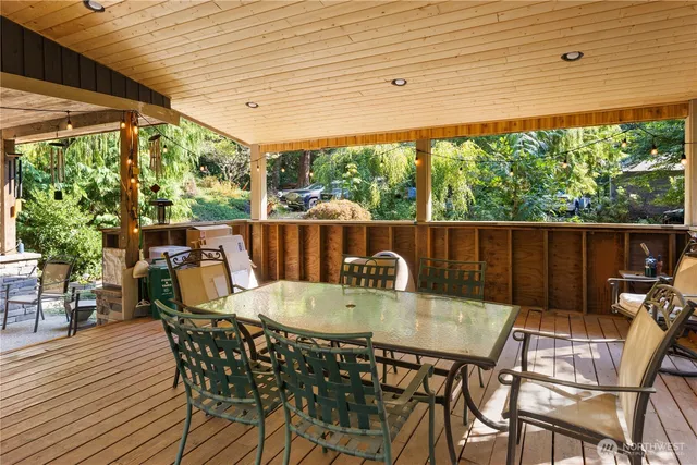 a view of a patio with a table chairs and backyard