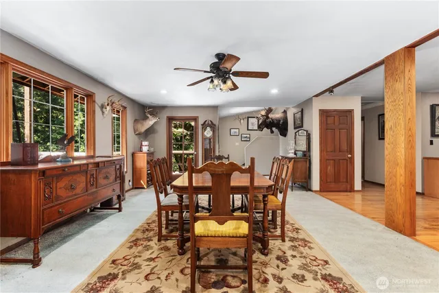 a dining room with furniture window and wooden floor