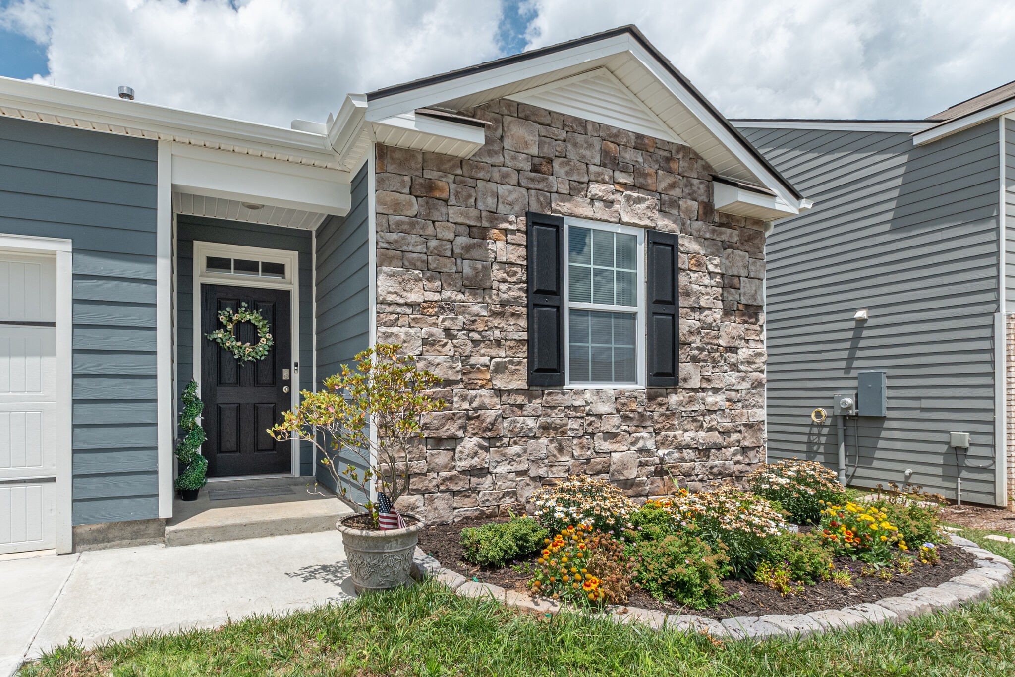 a front view of a house with garden