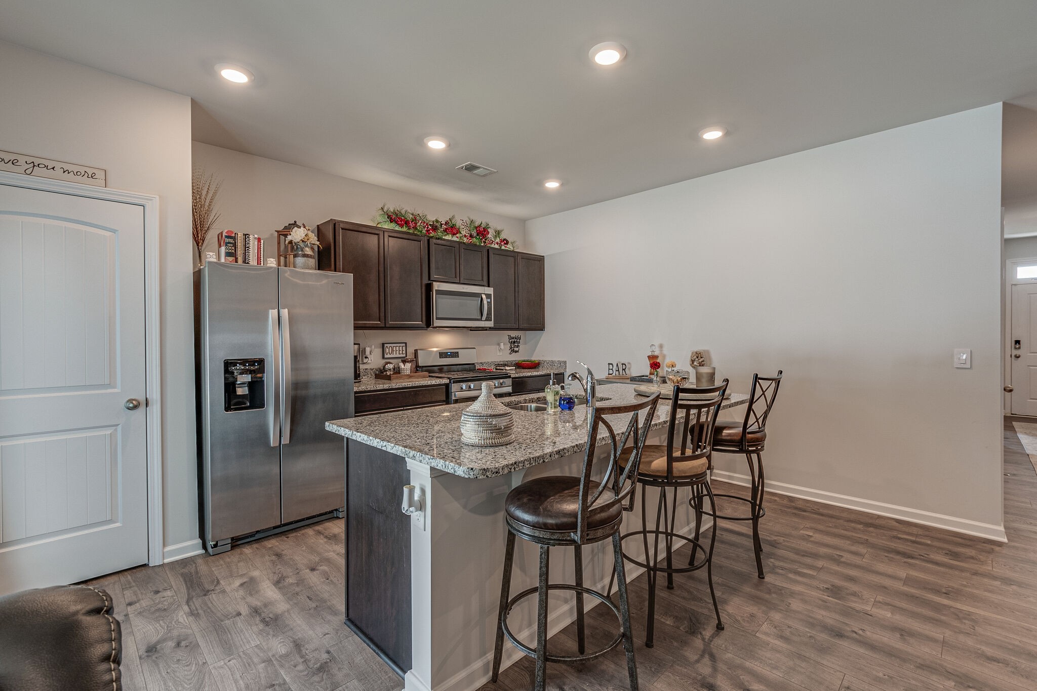 1122 Woodbridge Boulevard Lebanon, TN 37090 - Photo 13 of 30 a kitchen with stainless steel appliances a table chairs refrigerator and microwave