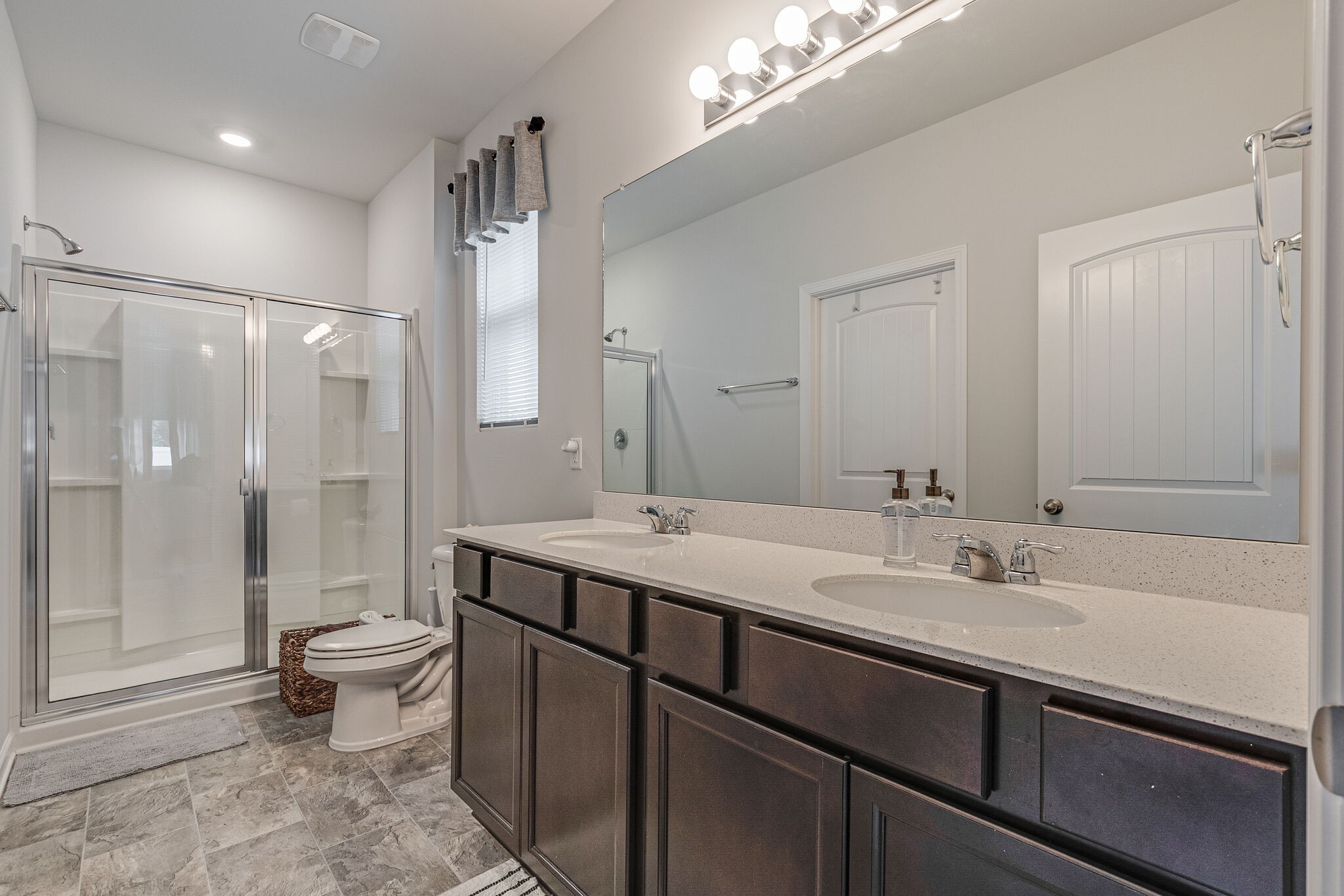1122 Woodbridge Boulevard Lebanon, TN 37090 - Photo 20 of 30 a bathroom with a sink a toilet a mirror and shower
