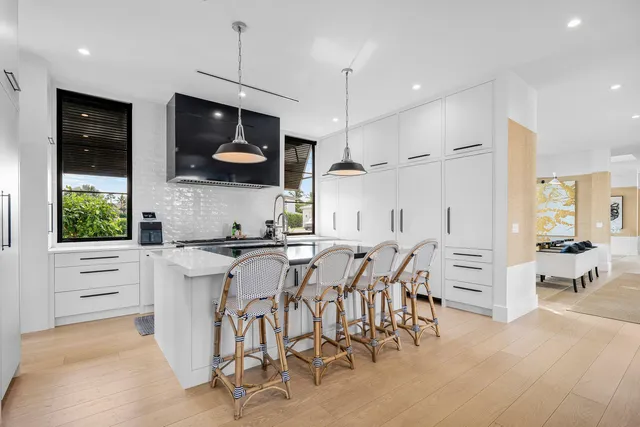 a view of a kitchen with kitchen island dining table and chairs