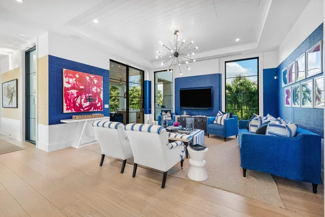 a living room with furniture kitchen view and a flat screen tv